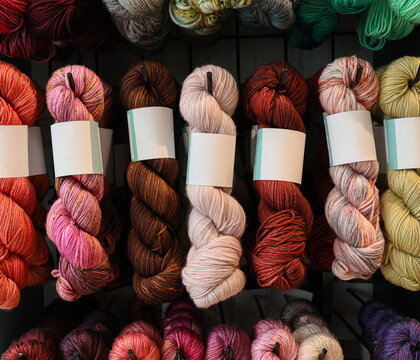 Collection of wool skeins exposed in a knitting shop.