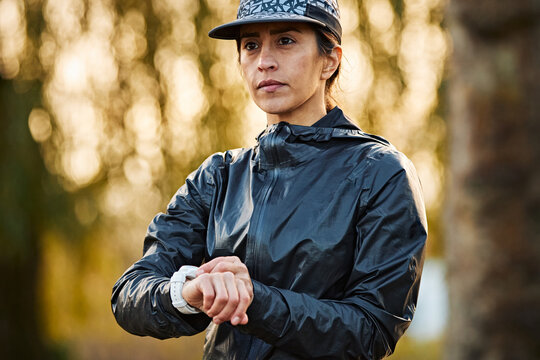 Female Runner Checking Sports Watch Before Training