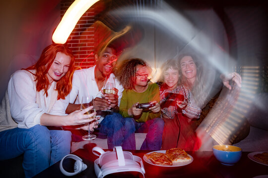 Friends enjoying gaming night with snacks and drinks