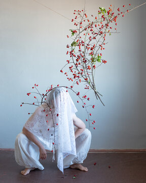 Woman squatting under the veil