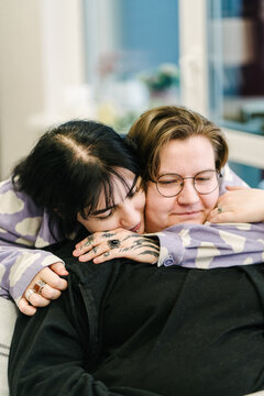 A couple hugs on the couch.