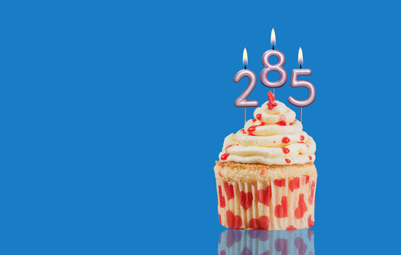Birthday Or Anniversary Cupcake With Lit Candles; Candles Forming The Number 285