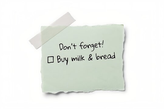 Handwritten note reminding to buy milk and bread with tape attached