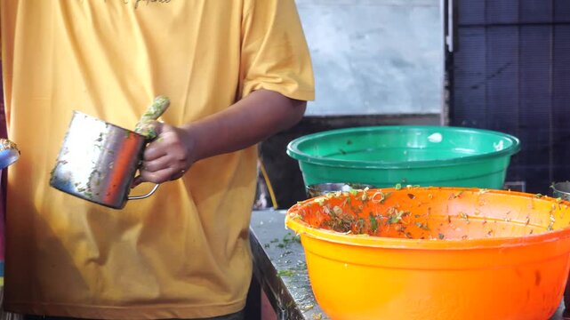 Food Vendor Mixing Egg and Beef Filling for Traditional Martabak Telor Kubang