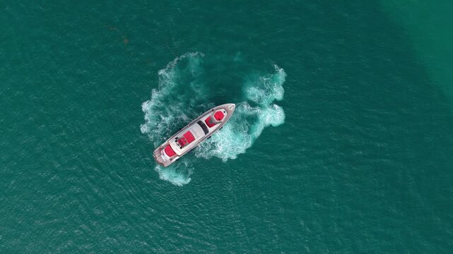 Motorboat glides beside luxury yacht through calm sea after leaving marina. Boat reaches open water. Summer vacation feels endless. Yacht returns with stunning views