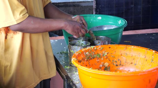 Food Vendor Mixing Egg and Beef Filling for Traditional Martabak Telor Kubang