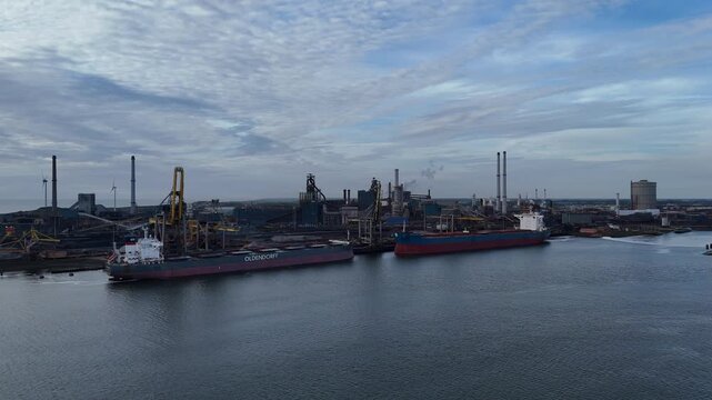 Two cargo vessels beside industrial terminal