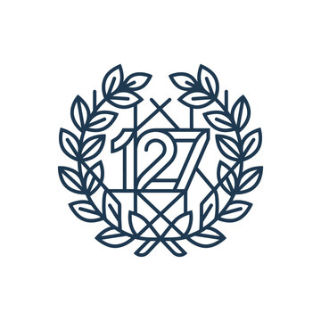 Geometric blue crest with number 127 and laurel.