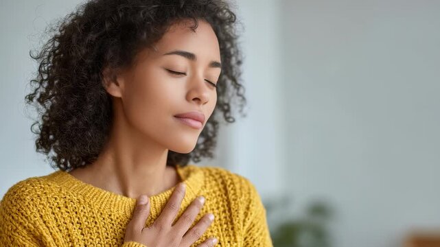Serene female enjoys a mindful moment, practicing gratitude and self care in a cozy indoor setting. Soft natural light highlights her relaxed expression and tranquil emotions