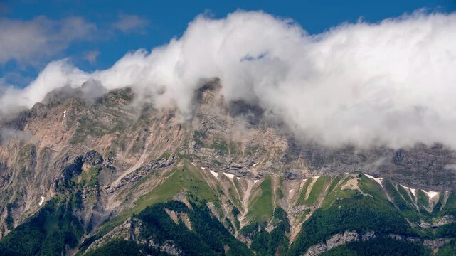 Faraut mountain range with a natural phenomenon of rolling clouds (timelapse). Champsaur Valley, Hautes-Alpes, France