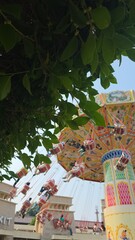Visitors of the amusement park are enjoying the wave swinger ride. Visitors are excited to try the swing ride at the amusement park © WarnaDunia