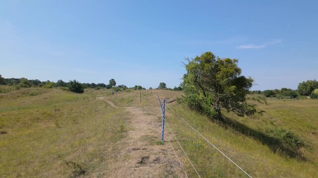 Barnack Hills and Holes, Cambridgeshire, UK - 11 June 2026: Walking along a ridge and showing wide open expanse and undulation within the landscape from on high either side