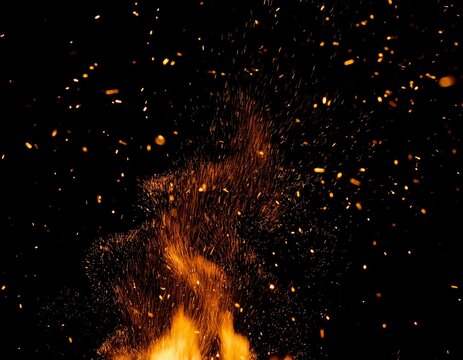 glowing sparks and ember particles flying upward on pure black background overlay