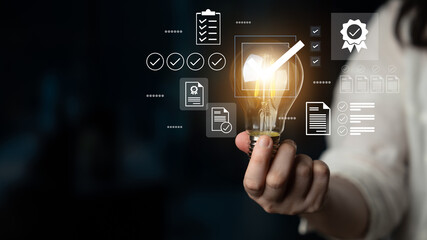 A hand holds a glowing light bulb, symbolizing creativity and innovation, accompanied by digital icons like checklists and documents, representing business planning and growth. Gantry © InfiniteFlow