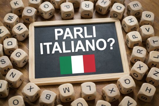 Parli italiano question on chalkboard with wooden letter blocks