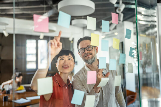 Business people collaborating on creative ideas using sticky notes
