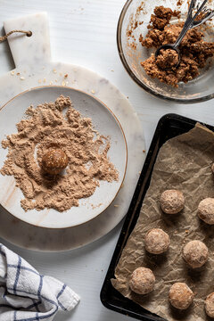 Preparing cinnamon coated high protein energy balls. 
