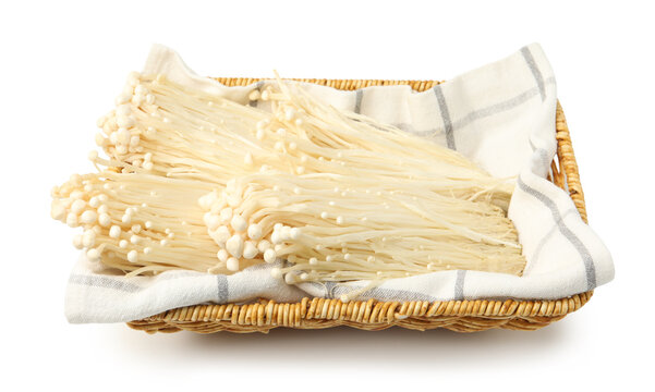 Raw enoki mushrooms in basket isolated on white