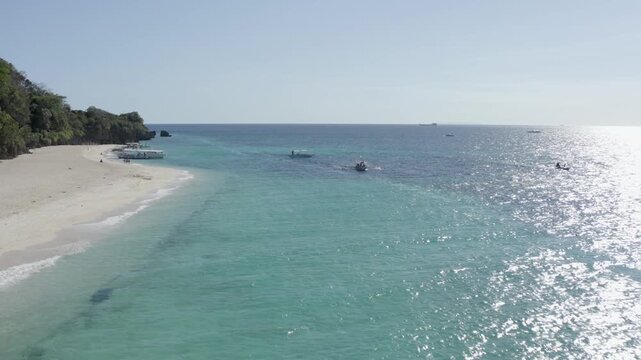 People Walking and Boats Off Shore at Puka Shell Beach Boracay Philipp