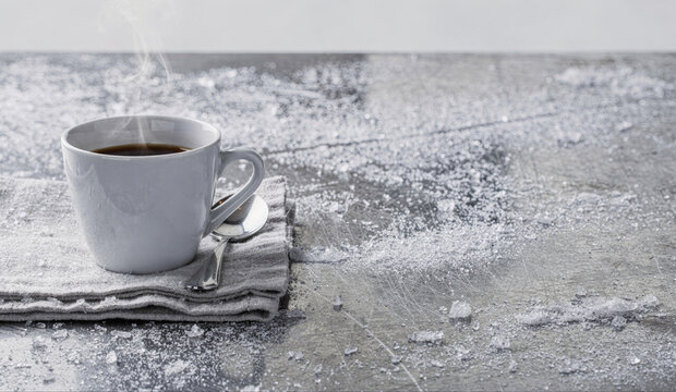 Steaming Coffee Cup on Snow-Dusted Rustic Table