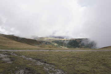 Scenic mountain landscape with low clouds and misty peaks © Damian