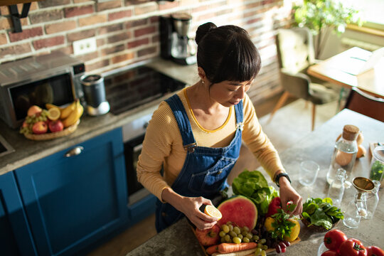 Woman preparing fresh produce in a home kitchen