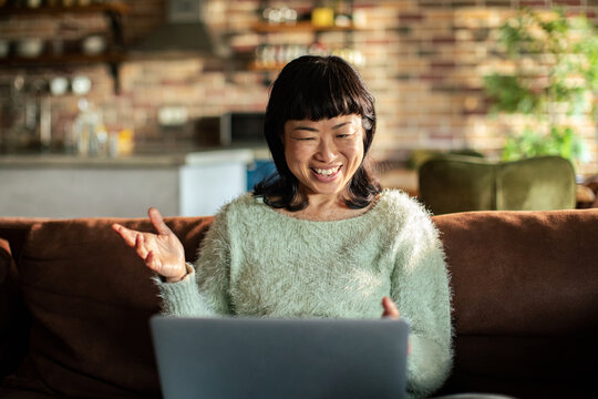 Smiling woman on video call at home