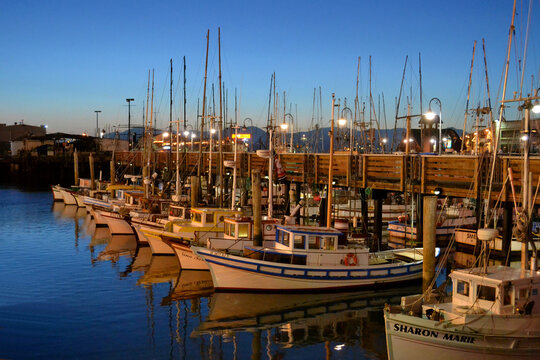 San Francisco CA -  Colorful fishing boats in Fisherman's Wharf at night dusk