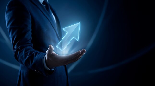 Businessman holding a glowing growth arrow. Digital concept of business success and progress.