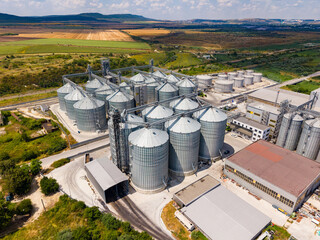 Grain storage facility located in a rural area with multiple silos and large buildings © DSMT