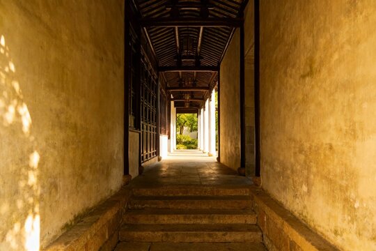 Traditional Chinese Corridor with Stone Steps and Wooden Roof