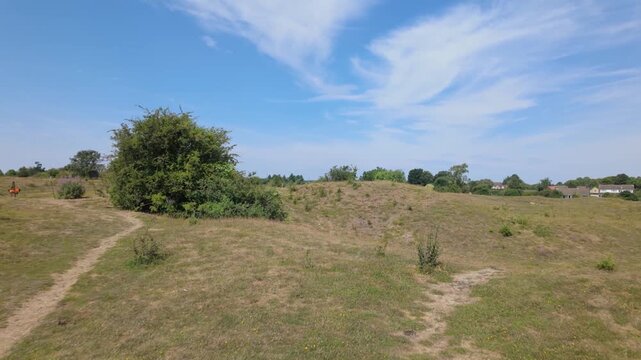 Barnack Hills and Holes, Barnack, Peterborough, Cambridgeshire, England, UK - June 11 2026: Walking across the top of one of the most open hills showing the wide expanse at the NNR