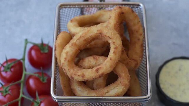 Deep fried breaded onion or squid rings, crispy fast food snacks. Fried onion or squid rings as a food background for your design