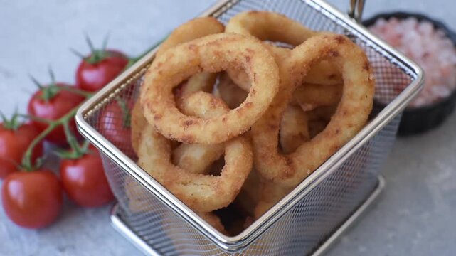 Deep fried breaded onion or squid rings, crispy fast food snacks. Fried onion or squid rings as a food background for your design