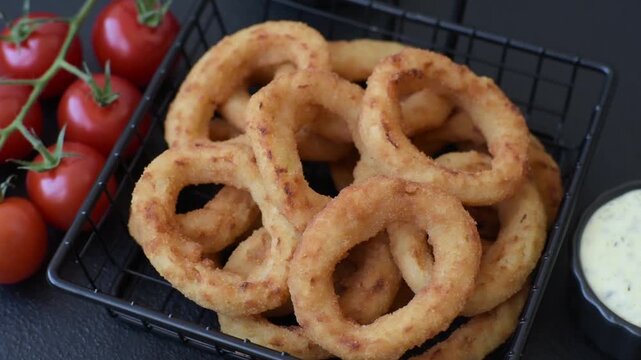 Deep fried breaded onion or squid rings, crispy fast food snacks. Fried onion or squid rings as a food background for your design