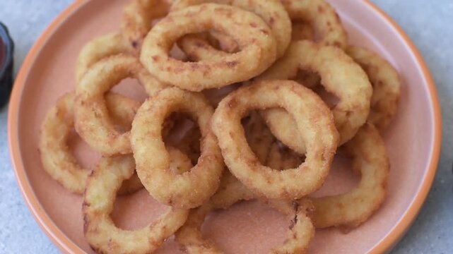 Deep fried breaded onion or squid rings, crispy fast food snacks. Fried onion or squid rings as a food background for your design