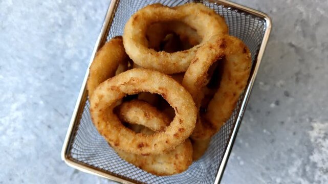 Deep fried breaded onion or squid rings, crispy fast food snacks. Fried onion or squid rings as a food background for your design