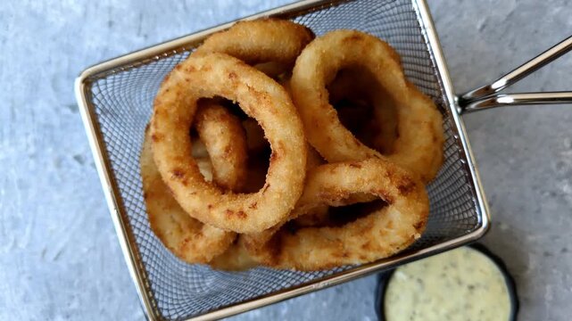 Deep fried breaded onion or squid rings, crispy fast food snacks. Fried onion or squid rings as a food background for your design
