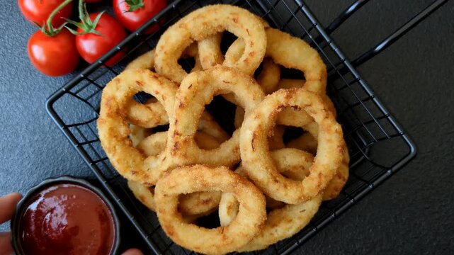 Deep fried breaded onion or squid rings, crispy fast food snacks. Fried onion or squid rings as a food background for your design