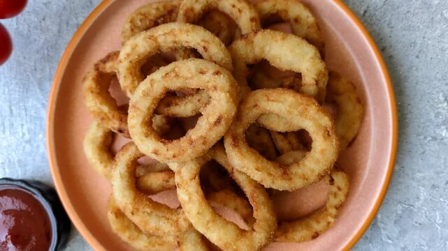 Deep fried breaded onion or squid rings, crispy fast food snacks. Fried onion or squid rings as a food background for your design