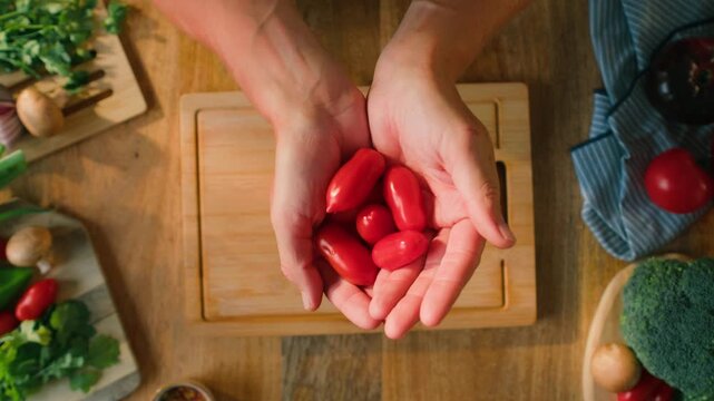 Chop tomato close up, Diced kumato tomatoes on a cutting board for Italian sauce, chef cut tomatoes with knife for gazpacho or salad 