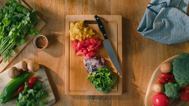 Salad mix, yellow sweet pepper, tomato, cilantro, parsley, Healthy food, Chef hands with knife for onion, cutting and preparation with cooking for dish. Restaurant stew. 