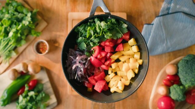 Salad mix, yellow sweet pepper, tomato, cilantro, parsley, Healthy food, Chef hands with knife for onion, cutting and preparation with cooking for dish. Restaurant stew. 