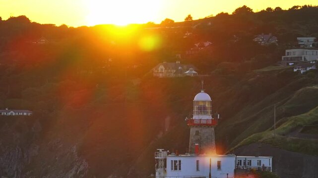 aerial 4k footage of Howth Head Lighthouse during sunset, Dublin Ireland