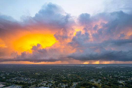 Thunderstorm. Dramatic sunset storm clouds over Tampa Bay Florida. Heavy rain shafts and glowing sky. Extreme weather, hurricane season, climate change, aerial landscape, Nature Photo. Gulf of Mexico