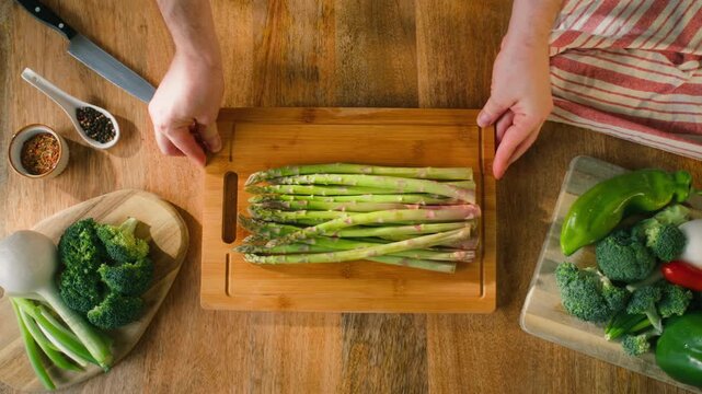 Fresh green asparagus on kitchen with broccoli and green pepper, vegan healthy food. Bunch of green asparagus close-up
