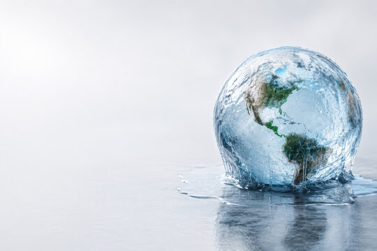 A frozen globe of Earth melts and drips on a wet surface. Space for text.