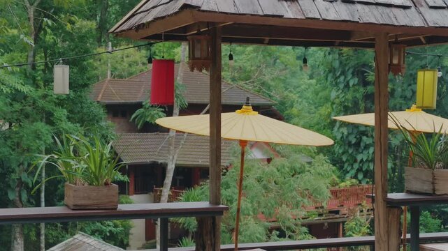 Rustic mountain terrace overlooking lush tropical forest and peaceful hillside resort, Cozy wooden veranda with scenic jungle views creating relaxing travel destination atmosphere 4k