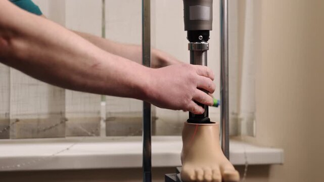 prosthetic foot, precision alignment, rehab clinic. In clinical lab, specialist uses laser-guided alignment system to calibrate prosthetic foot with high precision