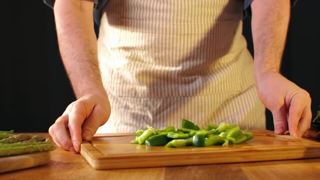 Man cut green sweet pepper, Healthy food, Chef hands with knife for onion, cutting and preparation with cooking for dish. Restaurant, culinary service and cook with skills for catering